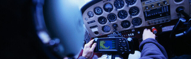 Airplane Pilot at Controls --- Image by © Lucidio Studio Inc./CORBIS